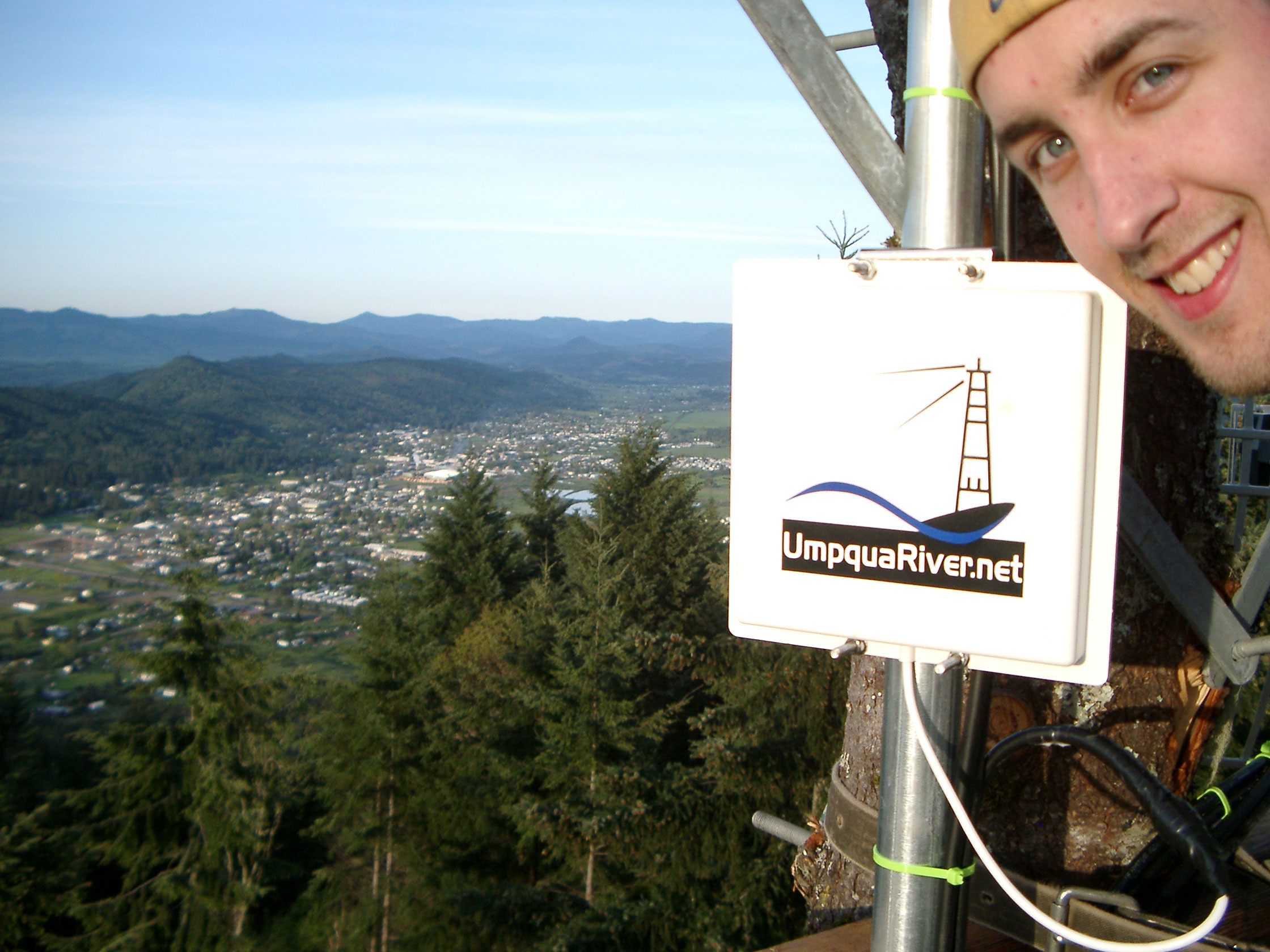 Cory on top of tree building wireless ISP